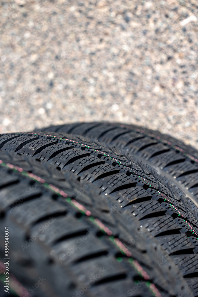 Sharp tread of new winter tires ready for the seasonal change. New tires are important for increasing road safety