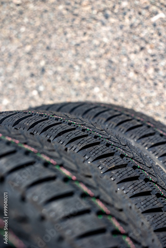 Obraz na płótnie Sharp tread of new winter tires ready for the seasonal change. New tires are important for increasing road safety w salonie