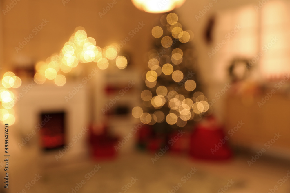 Interior of cozy living room with fireplace, shelving unit and glowing Christmas tree decorated for holiday at night, blurred view Interior of cozy living room with fireplace, shelving unit and glowing Christmas tree decorated for holiday at night, blurred view