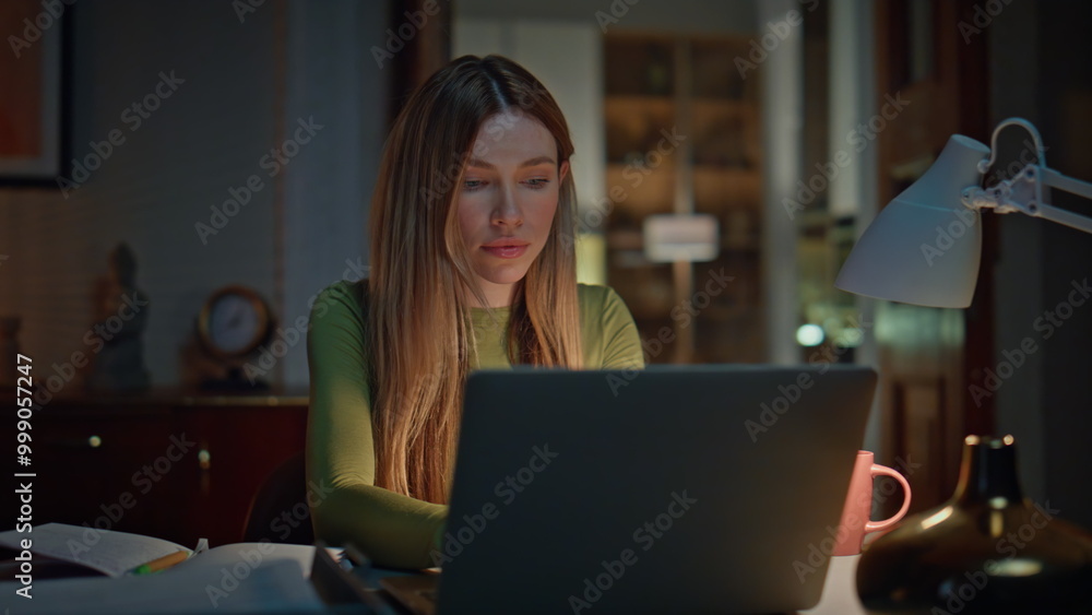 Online student studying late evening looking laptop. Woman freelancer working Online student studying late evening looking laptop. Woman freelancer working