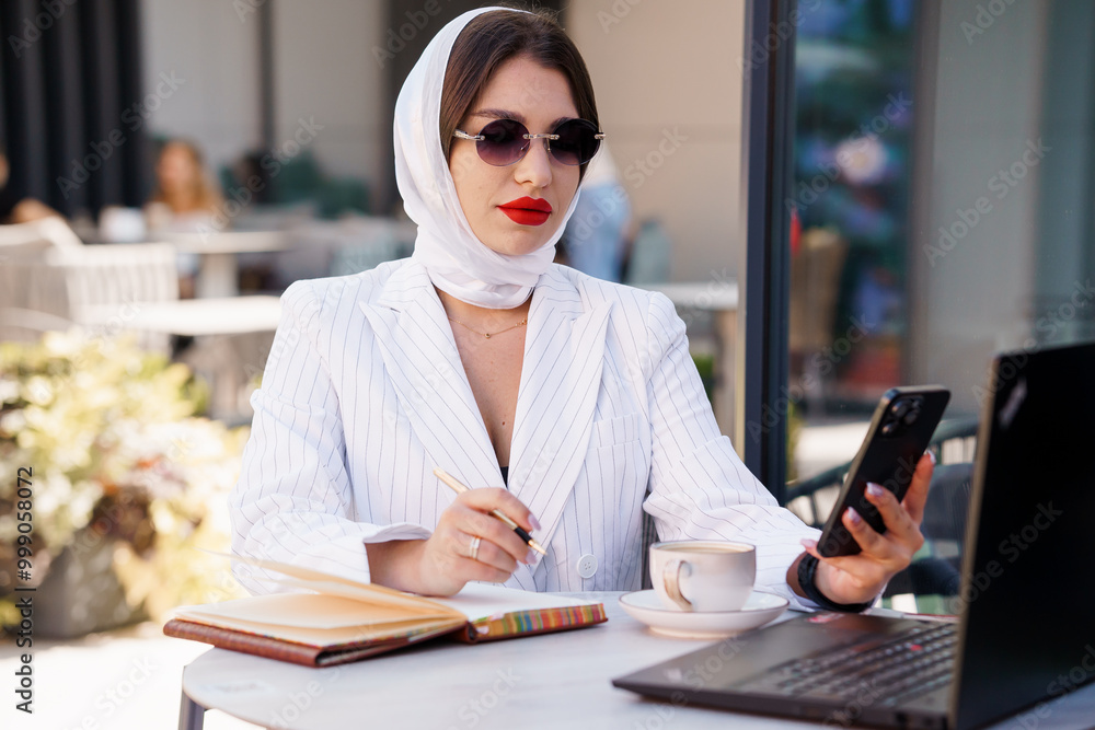 Elegant Business Woman Engaged in Work Outdoors with Laptop and Notebook Elegant Business Woman Engaged in Work Outdoors with Laptop and Notebook