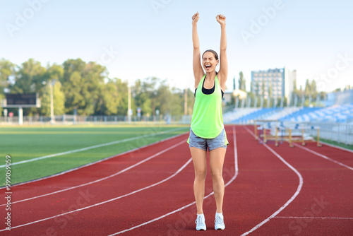 Happy young woman running a...