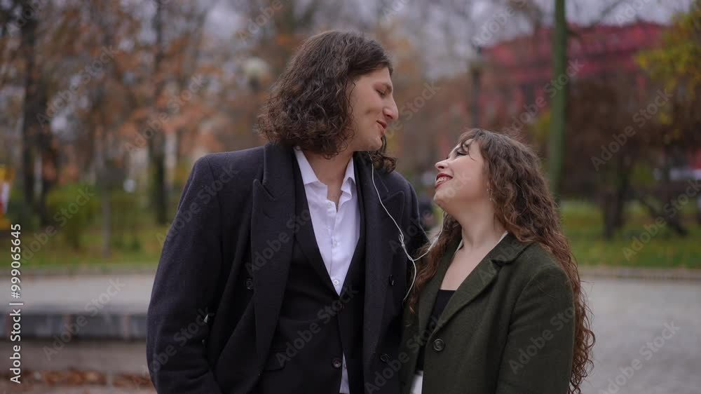 A beautiful and joyful couple relishing a delightful moment together in a serene and colorful autumn park A beautiful and joyful couple relishing a delightful moment together in a serene and colorful autumn park