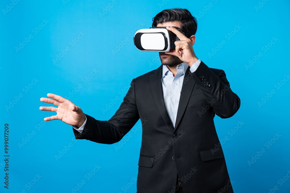 Smart business man with suit holding something while VR goggle to connect metaverse. Professional project manager looking at hologram by using visual reality headset. Technology innovation. Deviation. Smart business man with suit holding something while VR goggle to connect metaverse. Professional project manager looking at hologram by using visual reality headset. Technology innovation. Deviation.