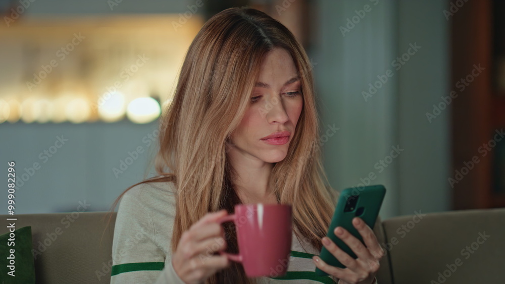 Resting freelancer drinking coffee looking smartphone in apartment sofa close up Resting freelancer drinking coffee looking smartphone in apartment sofa close up