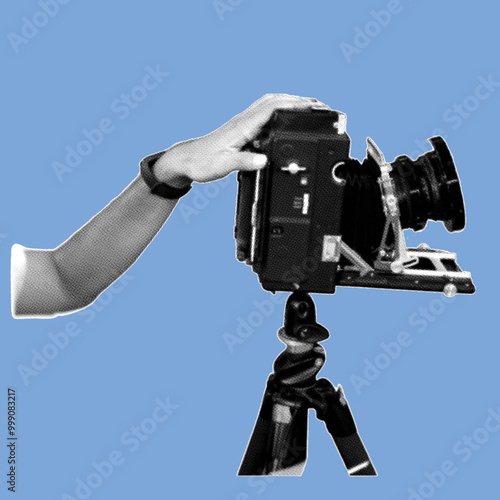 close up side view of hand holding large format camera pixelate grayscale color halftone dotted texture style collage element isolated on blue background