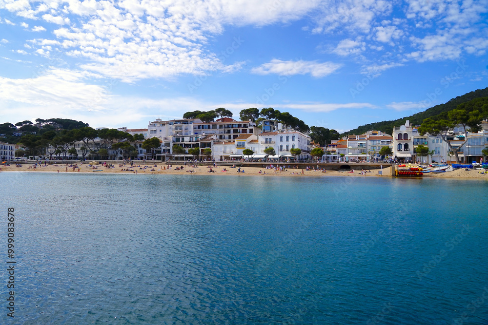view from the port to the promenade with restaurants, little shops and boutiques directly at the beautiful beach in Llafranc, Camí de Ronda, Costa Brava, Girona, Catalonia, Spain view from the port to the promenade with restaurants, little shops and boutiques directly at the beautiful beach in Llafranc, Camí de Ronda, Costa Brava, Girona, Catalonia, Spain