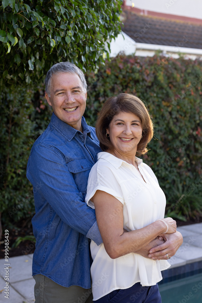 Smiling senior couple embracing outdoors, enjoying time together in garden, at home Smiling senior couple embracing outdoors, enjoying time together in garden, at home