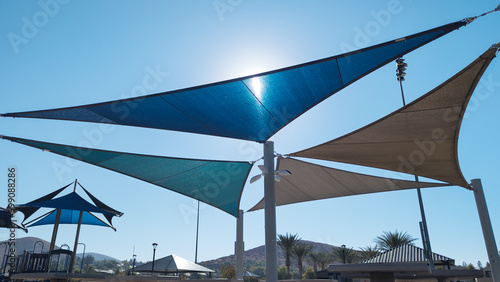 Colorful sail shades over picnic tables at a public park