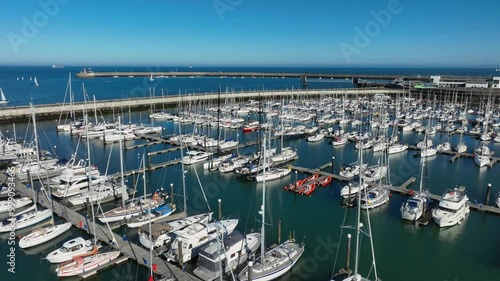 Dún Laoghaire Marina, County Dublin, Ireland, September 2024. Drone orbits clockwise above moored sailing boats and yachts revealing the view east towards and Sandycove and Killiney in the distance. photo