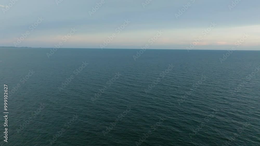 Calm Ocean Waves Near the Shoreline at Dusk With Soft Colors and Tranquility Calm Ocean Waves Near the Shoreline at Dusk With Soft Colors and Tranquility