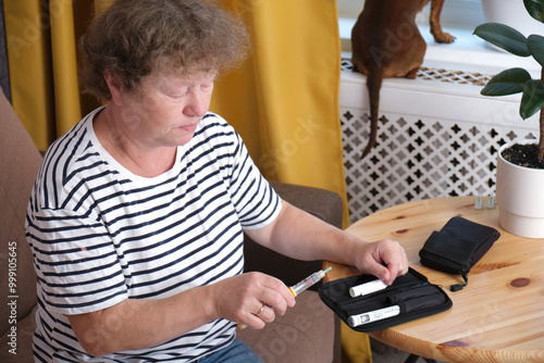 middle aged woman preparing syringe pen with insulin for injection, diabetes concept, diabetes awareness day November 15