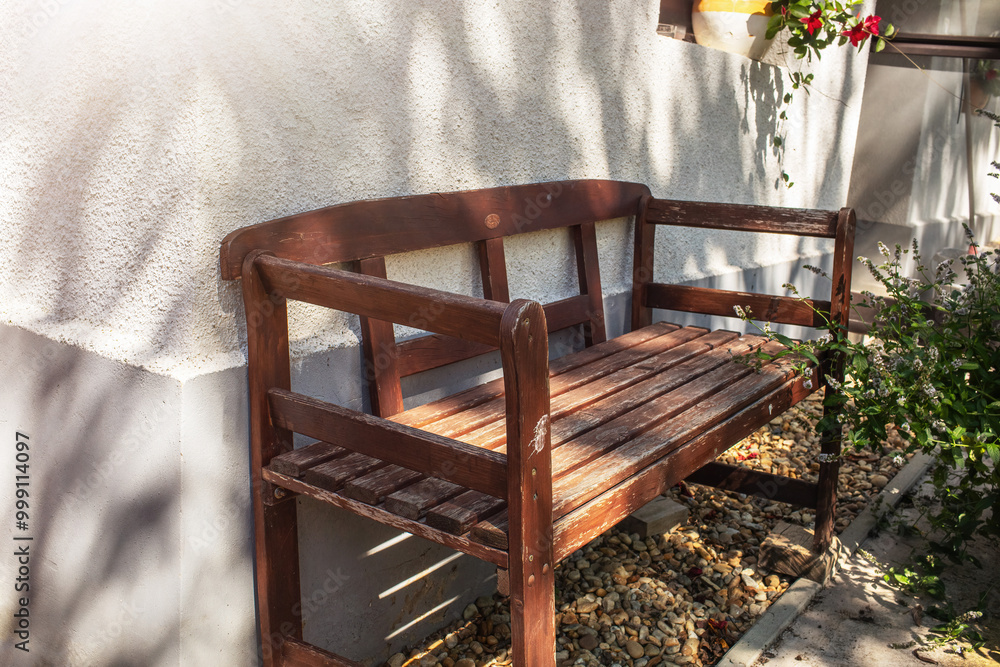 Wooden bench at the corner of the house.Summer season Wooden bench at the corner of the house.Summer season