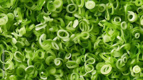 a close-up, top-down view of shredded green onions spread across the entire frame, filling the image with their vibrant green color and fine, delicate texture