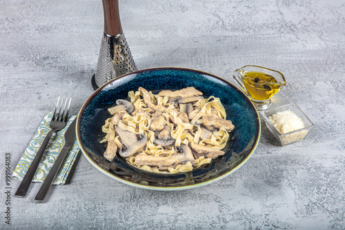 Creamy Alfredo pasta with chicken, mushrooms and parmesan cheese. Healthy Italian dish. photo