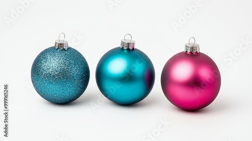 Three Christmas ornaments, one blue, one pink, and one purple