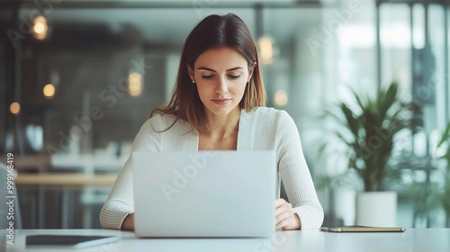 Professional Woman Working on Laptop in Modern Office