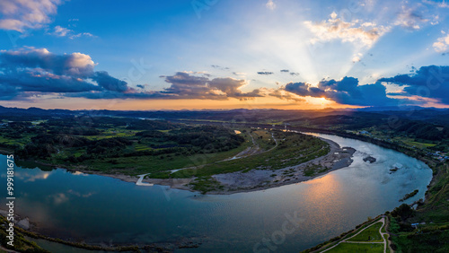 Aerial and sunset view of rice paddy field and Imjingang River near Yeoncheon Horogoru at Yeoncheon-gun, South Korea photo