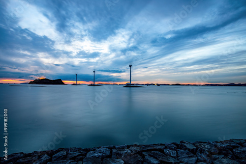 Sunset and long exposure view of wind power generator at Tando Port near Ansan-si, South Korea photo