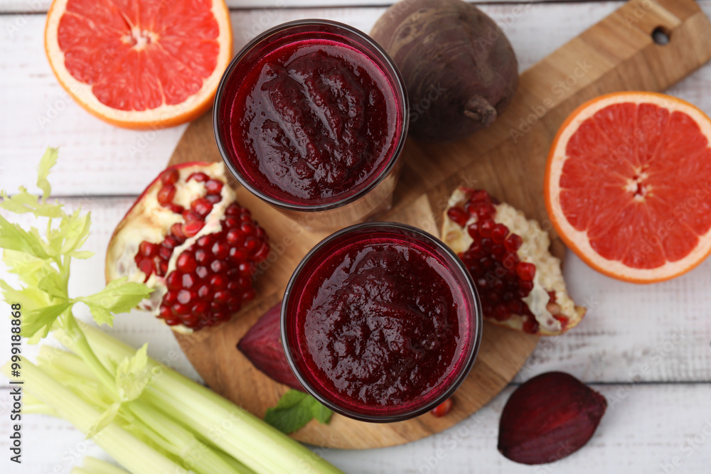 Fresh beetroot smoothie in glasses, grapefruit, beet and pomegranate on white wooden table, flat lay Fresh beetroot smoothie in glasses, grapefruit, beet and pomegranate on white wooden table, flat lay