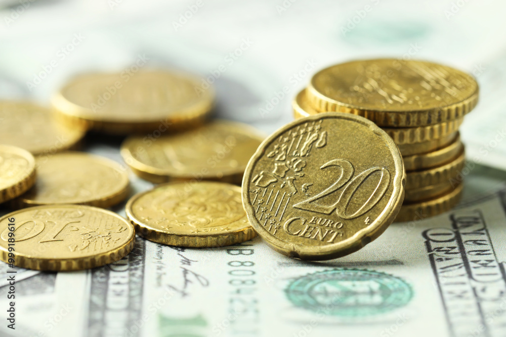Many euro coins on dollar banknotes, closeup Many euro coins on dollar banknotes, closeup