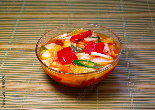 Close up of Korean food Mulgimchi(Water Cabbage Kimchi) in a glass bown on the bamboo floor, South Korea photo