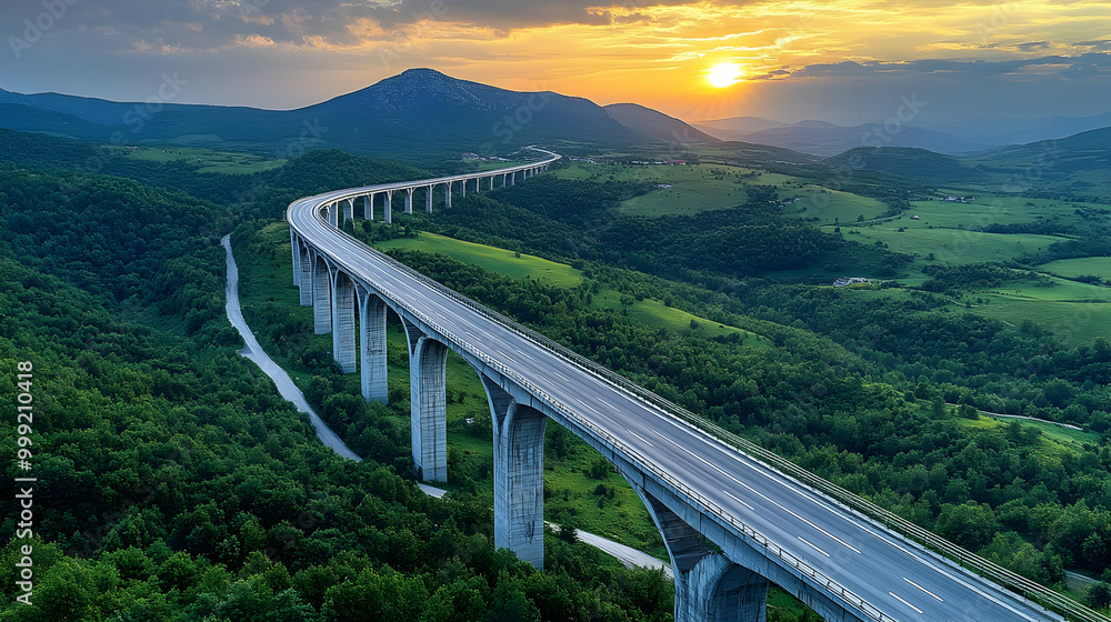 Highway Bridge Over Lush Green Valley at Sunset