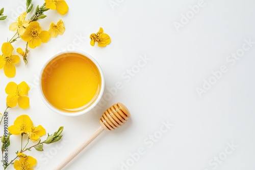 Drops of honey and dipper on white background, top view