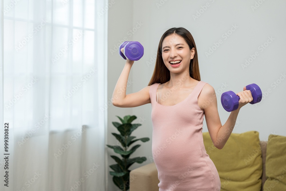 Young pregnant woman doing exercise using dumbbell at home, pregnancy sport girl taking care her body and healthy lifestyle of motherhood concept Young pregnant woman doing exercise using dumbbell at home, pregnancy sport girl taking care her body and healthy lifestyle of motherhood concept