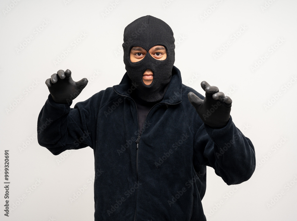 Thief in uniform black jacket various pose on isolated background. The Robber terrorism criminal escapes with balaclava and crowbar entering a house for stealing Housebreak Thief in uniform black jacket various pose on isolated background. The Robber terrorism criminal escapes with balaclava and crowbar entering a house for stealing Housebreak