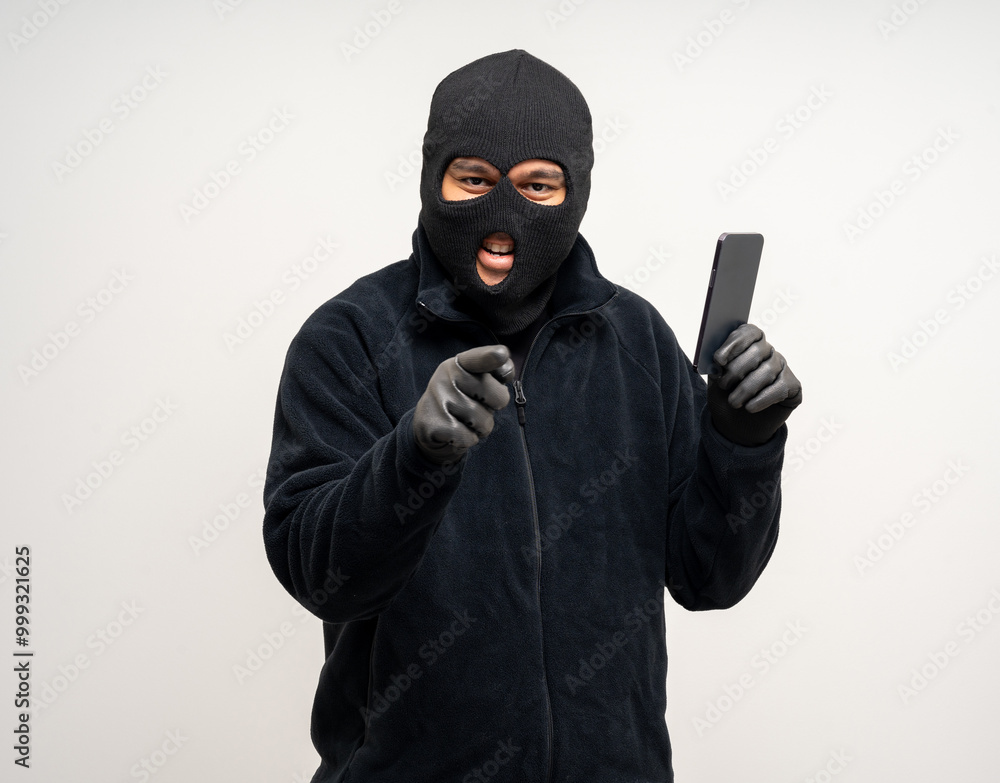 Thief in uniform black jacket various pose on isolated background. The Robber terrorism criminal escapes with balaclava and crowbar entering a house for stealing Housebreak Thief in uniform black jacket various pose on isolated background. The Robber terrorism criminal escapes with balaclava and crowbar entering a house for stealing Housebreak