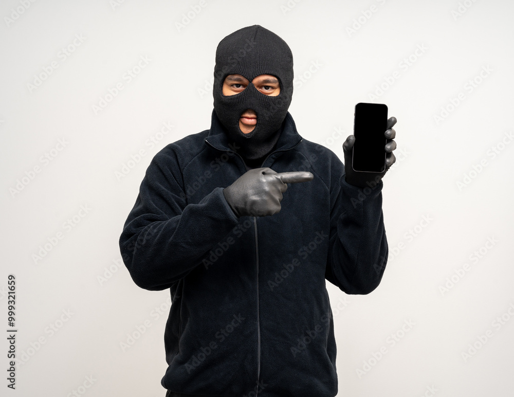 Thief in uniform black jacket various pose on isolated background. The Robber terrorism criminal escapes with balaclava and crowbar entering a house for stealing Housebreak Thief in uniform black jacket various pose on isolated background. The Robber terrorism criminal escapes with balaclava and crowbar entering a house for stealing Housebreak