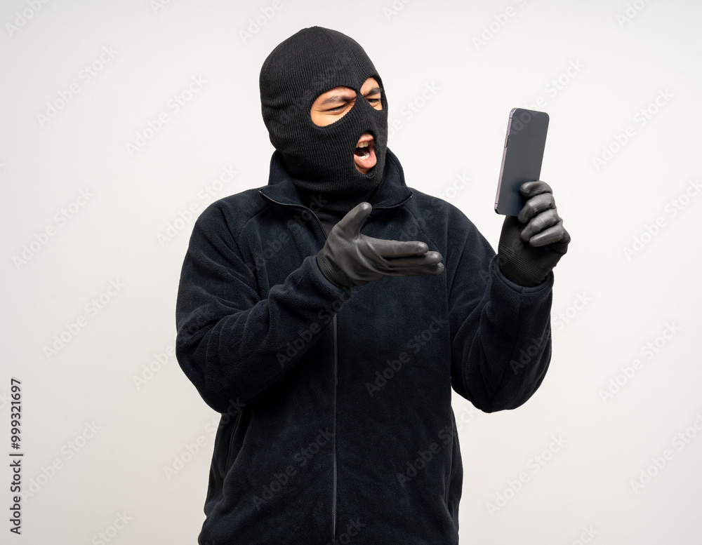 Thief in uniform black jacket various pose on isolated background. The Robber terrorism criminal escapes with balaclava and crowbar entering a house for stealing Housebreak Thief in uniform black jacket various pose on isolated background. The Robber terrorism criminal escapes with balaclava and crowbar entering a house for stealing Housebreak