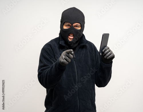 Thief in uniform black jacket various pose on isolated background. The Robber terrorism criminal escapes with balaclava and crowbar entering a house for stealing Housebreak