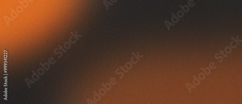 orange blurred gradient on dark grainy background, glowing light spot, copy space photo