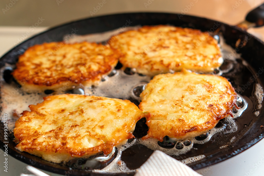 Zucchini fritters sizzle in a skillet, golden and crispy, embodying the essence of healthy comfort food. Their inviting aroma fills the air, promising a delightful culinary experience Zucchini fritters sizzle in a skillet, golden and crispy, embodying the essence of healthy comfort food. Their inviting aroma fills the air, promising a delightful culinary experience