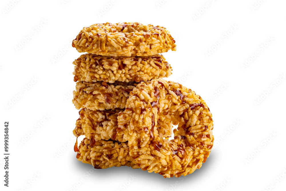Side view tower stack of crispy homemade rice crackers with cane sugar syrup isolated on white background with clipping path, closeup. Side view tower stack of crispy homemade rice crackers with cane sugar syrup isolated on white background with clipping path, closeup.