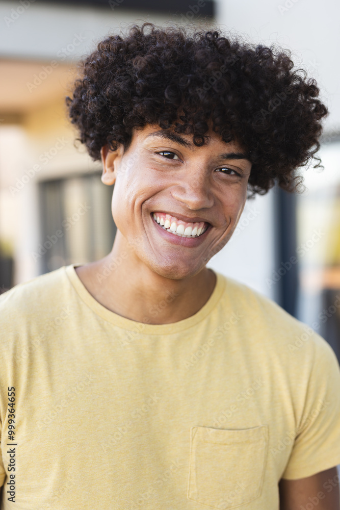 Smiling young man in yellow shirt enjoying time with diverse friends outdoors, at home Smiling young man in yellow shirt enjoying time with diverse friends outdoors, at home