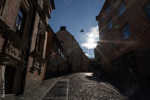 Stockholm, Sweden - 23rd of July 2023. A steep cobblestone street in the early morning sun in Stockholm, Sweden. photo