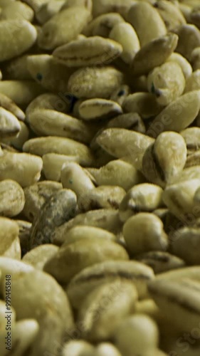 Close up of unroasted coffee beans background. Stock footage. A pile of many green unroasted ethiopian coffee seeds for the beverage preparation. photo