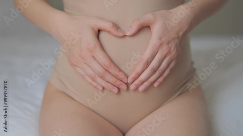 Wallpaper Mural pregnant woman indoors. health pregnancy motherhood procreation. Closeup belly of a pregnant woman. woman waiting for a newborn baby. pregnant woman holding her belly. Closeup belly in beige underwear Torontodigital.ca