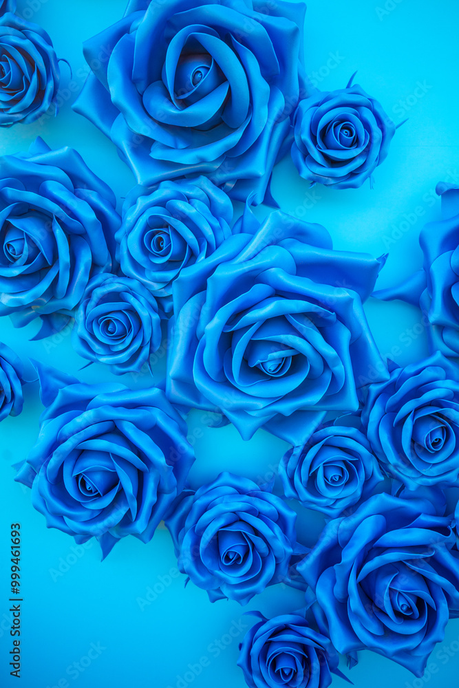 Blue floral background from artificial roses flowers. Vertical photo Blue floral background from artificial roses flowers. Vertical photo