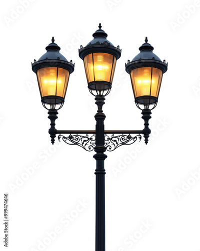 Elegant street lamp with three warm glowing lights on a black ornate stand against white isolate background. photo