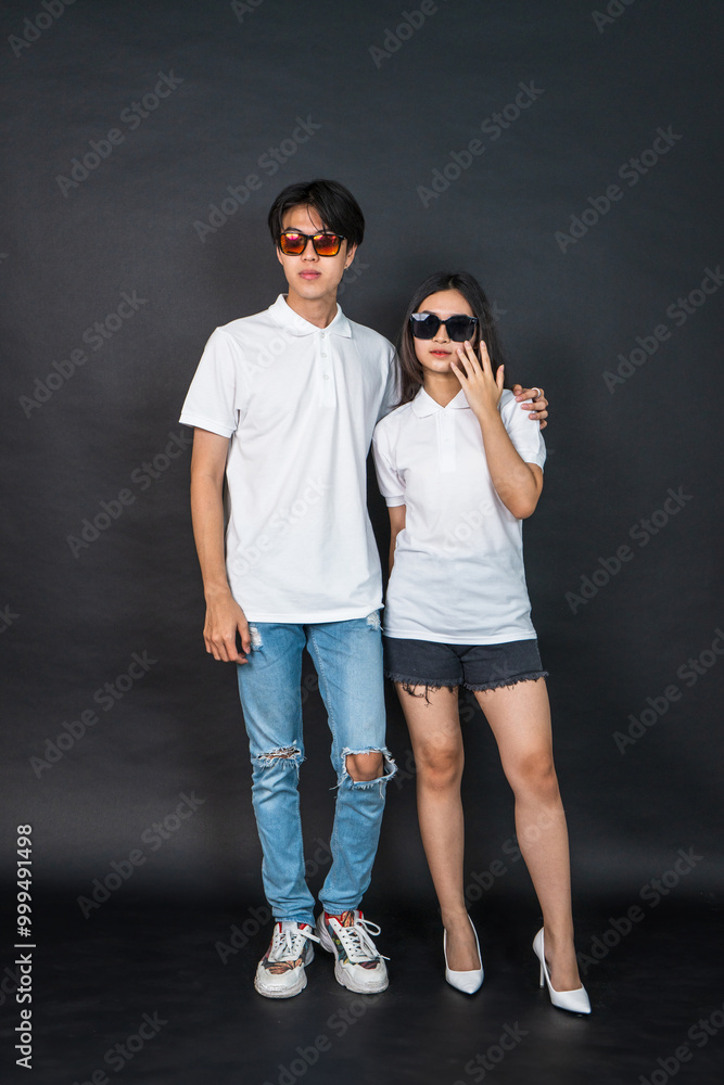 An Asian Couple Wearing White Polo Shirt Doing a Pose With Black Background An Asian Couple Wearing White Polo Shirt Doing a Pose With Black Background
