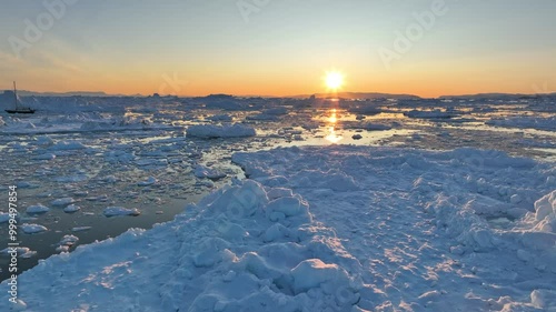 Wallpaper Mural Sunset in Greenland nature. Aerial view of setting sun and pieces of melted icebergs. Glaciers melting, global warming, arctic nature landscape Torontodigital.ca