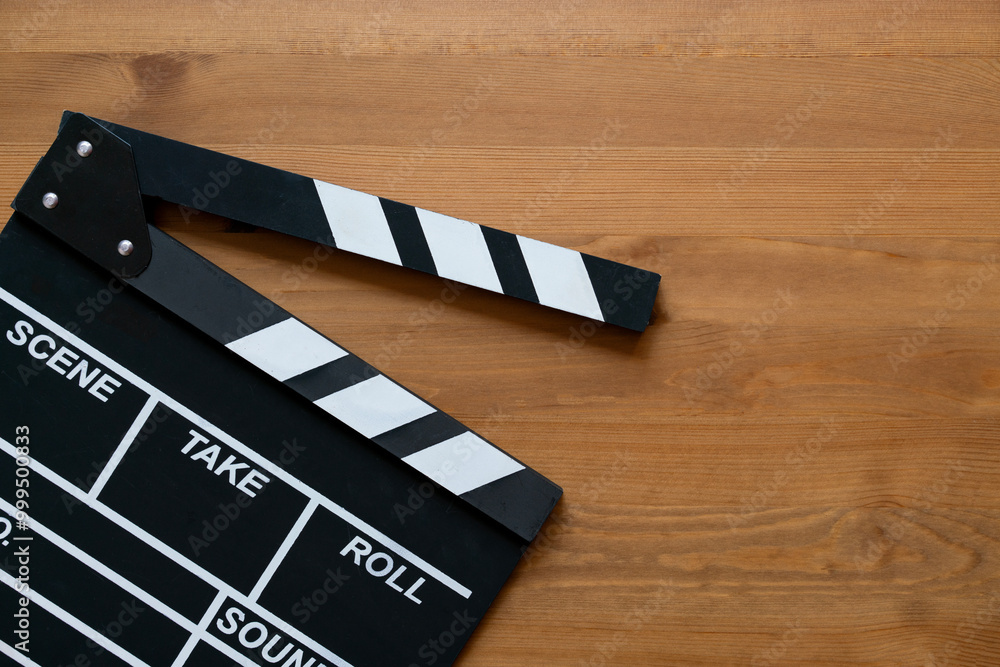 Obraz premium movie clapper on wood table ; film, cinema and video photography concept