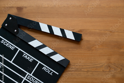 movie clapper on wood table ; film, cinema and video photography concept