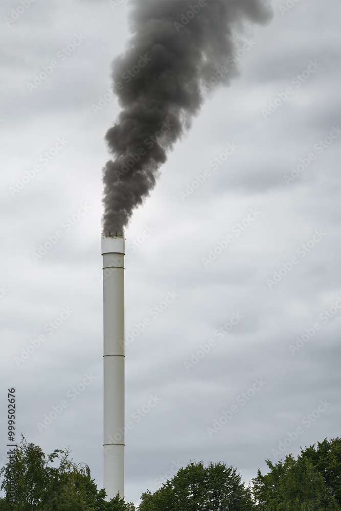 Industrial chimney releasing smoke on cloudy day Industrial chimney releasing smoke on cloudy day