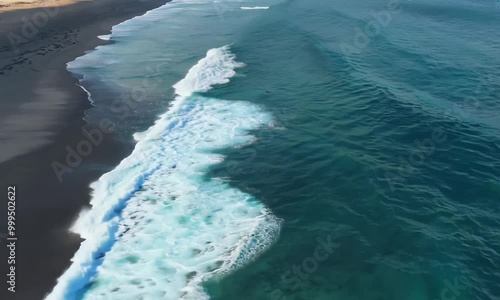 Aerial view of beautiful transparent clear sea waves and splashes of foam