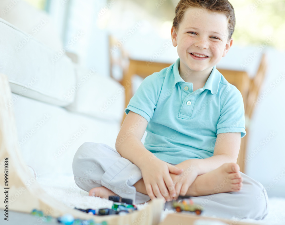 House, boy and happy with toy cars on portrait for fun on school break on floor in Scotland. Male person, kid and smile at home with playing for child growth, care and brain development at lounge House, boy and happy with toy cars on portrait for fun on school break on floor in Scotland. Male person, kid and smile at home with playing for child growth, care and brain development at lounge